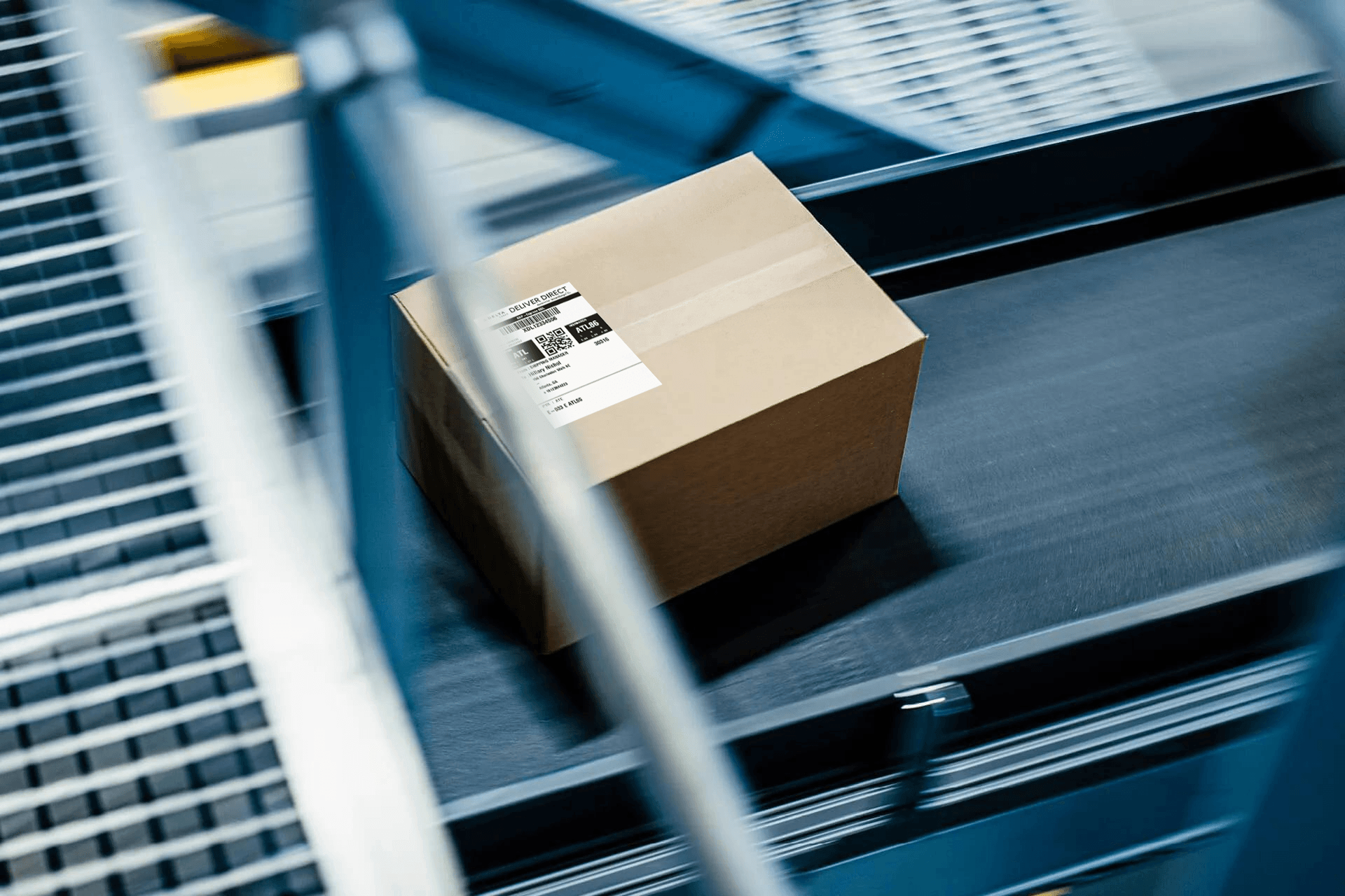 Small parcel moving on an automated conveyor belt for fast e-commerce order fulfillment